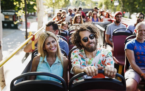 Tourists enjoying a ride on a double-decker bus during the Potsdam Hop-On-Hop-Off Tour.