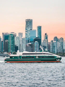 Ferry traveling from Nanaimo to Vancouver with city skyline in the background.