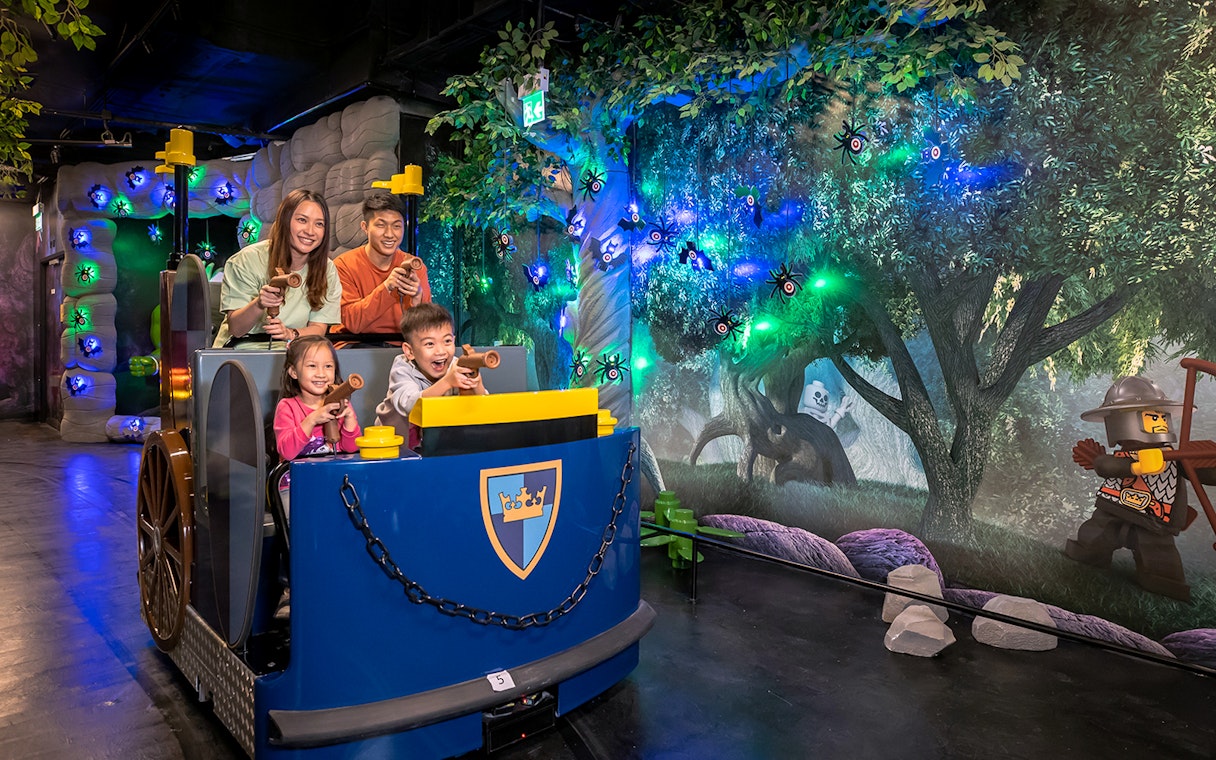 Family enjoying interactive ride at LEGOLAND® Discovery Centre Hong Kong.