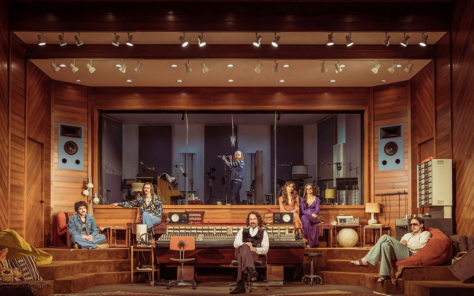 Recording studio with musicians and sound engineers, featuring vintage equipment, related to Stereophonic.