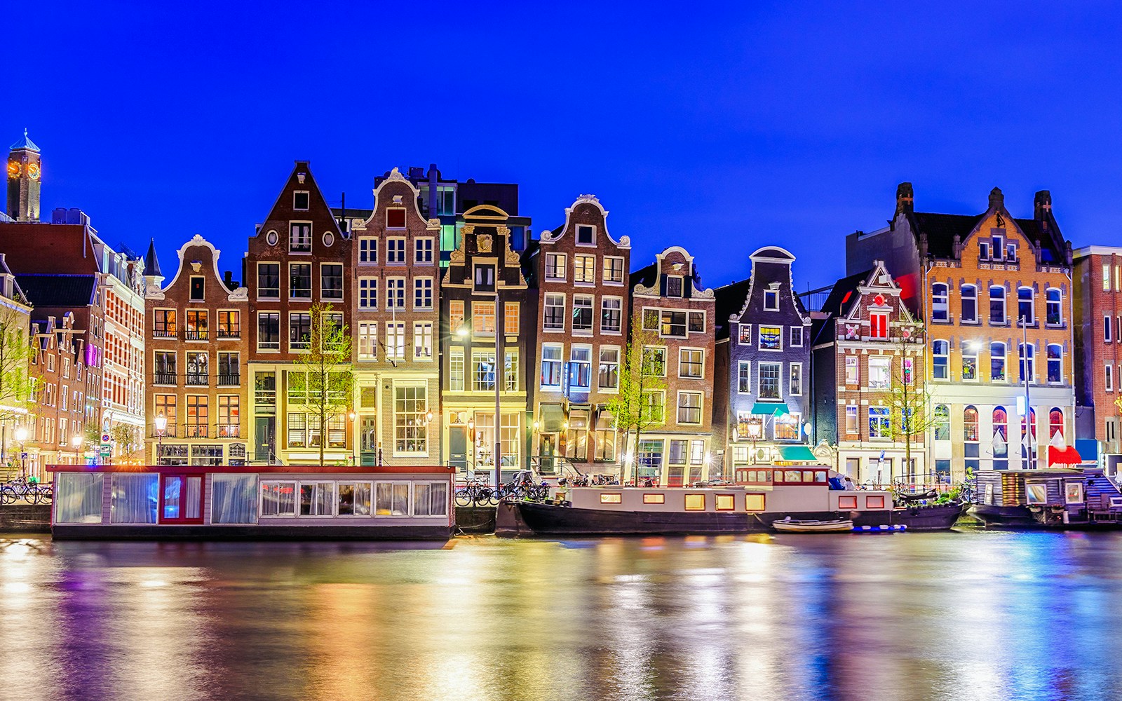 Colorful canal houses along the water in Amsterdam, Netherlands.