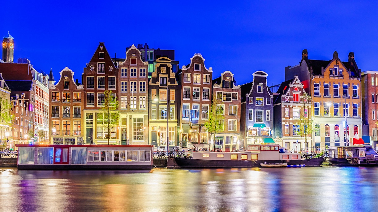 Colorful canal houses along the water in Amsterdam, Netherlands.