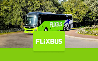 FlixBus traveling to Efteling from Amsterdam on a scenic road.