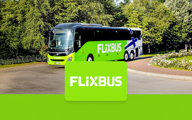 FlixBus traveling to Efteling from Amsterdam on a scenic road.