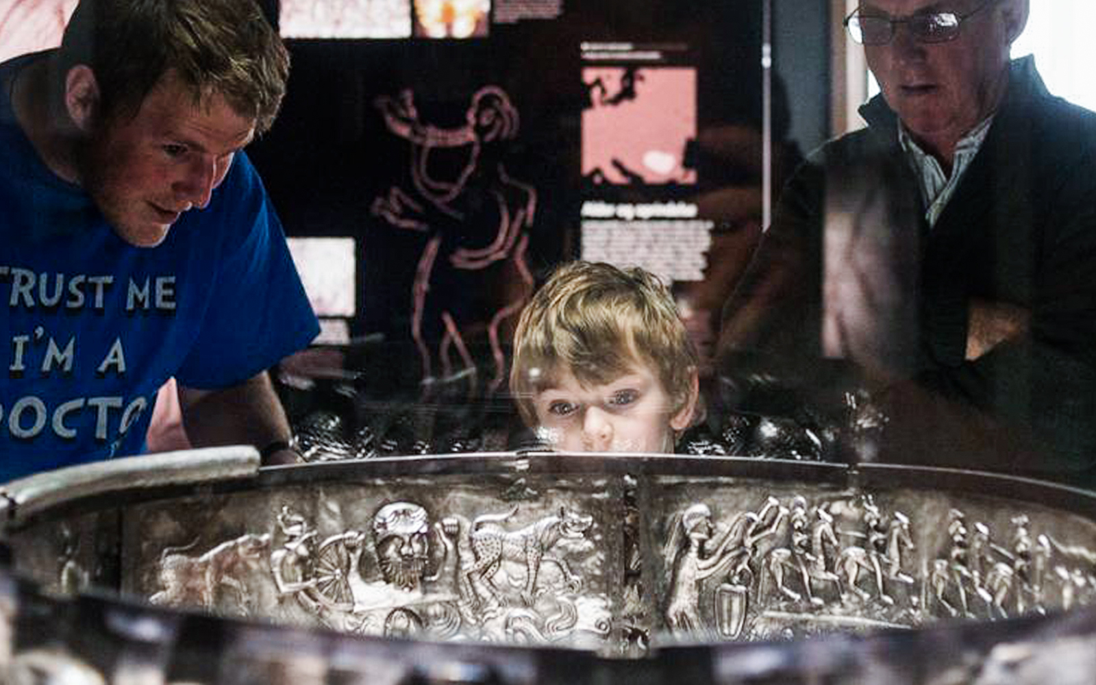 Visitors examining the Gundestrup Cauldron at the National Museum of Denmark.