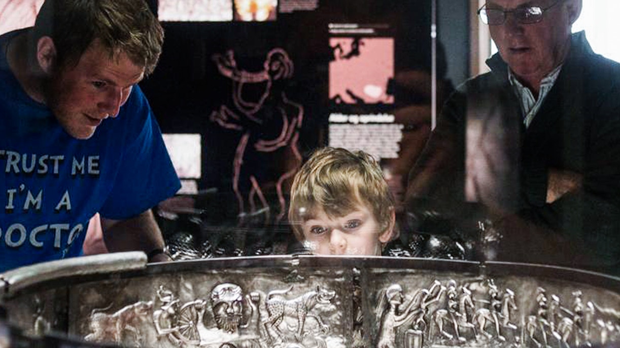 Visitors examining the Gundestrup Cauldron at the National Museum of Denmark.