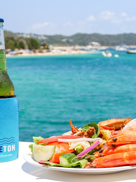 Seafood platter and drink with Moreton Bay view in Brisbane, Australia.