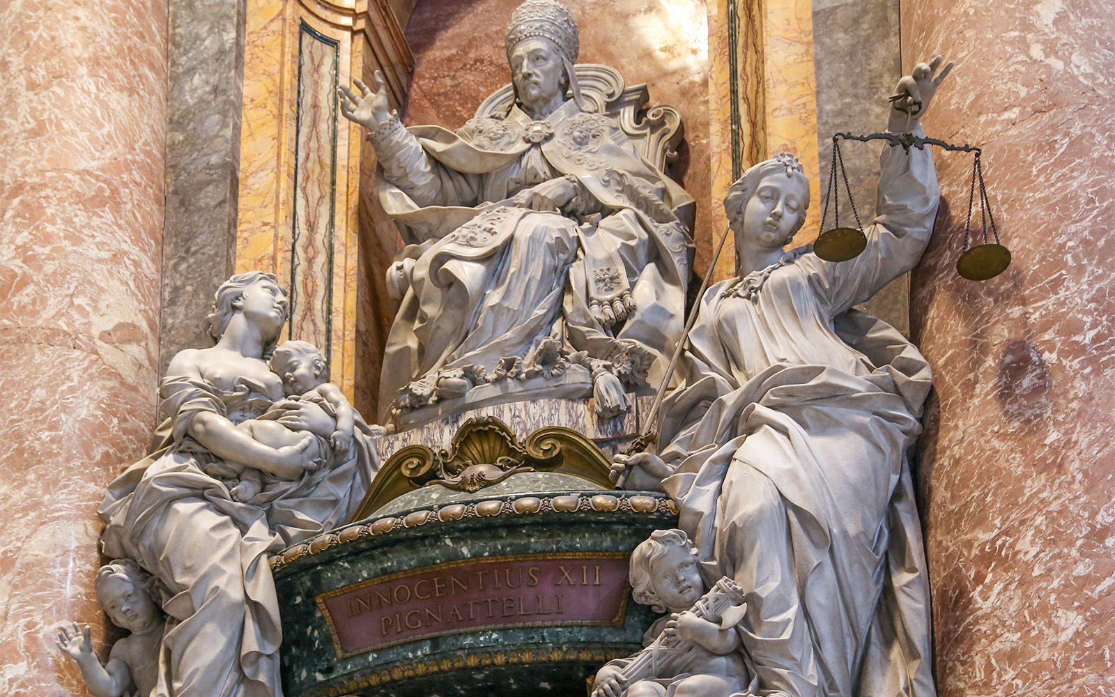 Statue of Pope Innocent XII with allegorical figures inside St. Peter's Basilica, Vatican City.