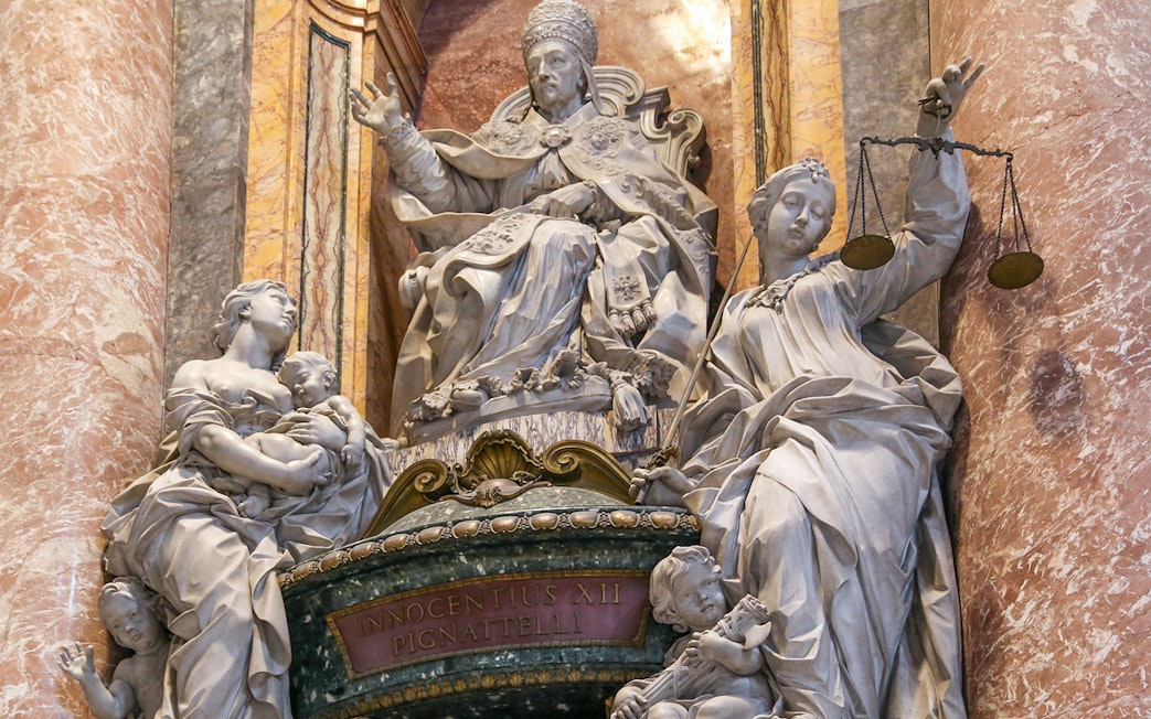 Statue of Pope Innocent XII with allegorical figures inside St. Peter's Basilica, Vatican City.