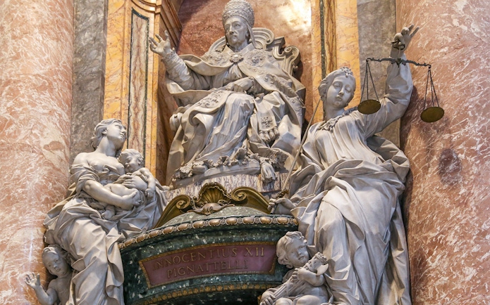 Statue of Pope Innocent XII with allegorical figures inside St. Peter's Basilica, Vatican City.