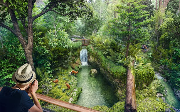 Tourists photographing wildlife near a waterfall in Rainforest Wild Asia.