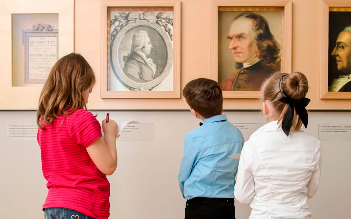 Children observing portraits at Mozarthaus Vienna.
