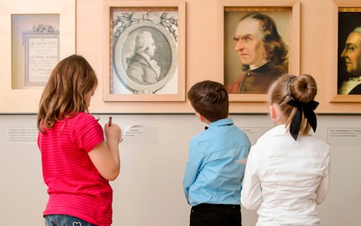 Children observing portraits at Mozarthaus Vienna.