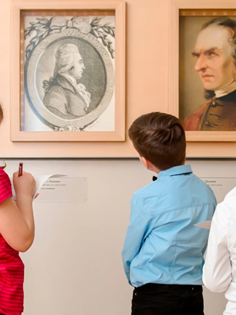 Children observing portraits at Mozarthaus Vienna.