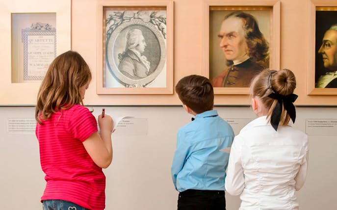 Children observing portraits at Mozarthaus Vienna.