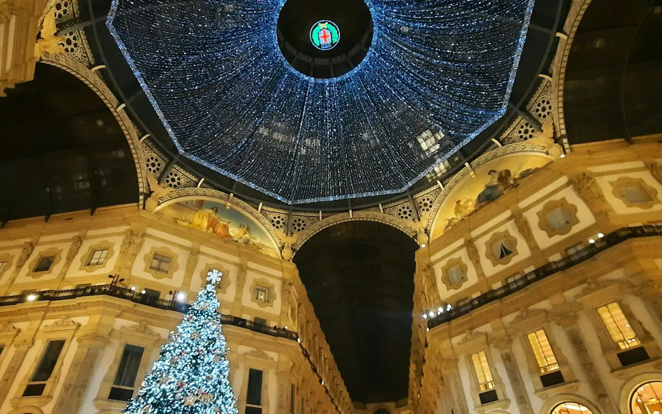 Galleria Vittorio Emanuele II dome with Christmas lights and tree, Milan.