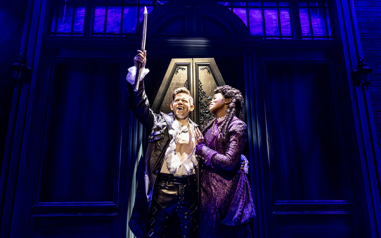 Actors performing in "Dracula, A Comedy of Terrors" on stage with dramatic lighting.