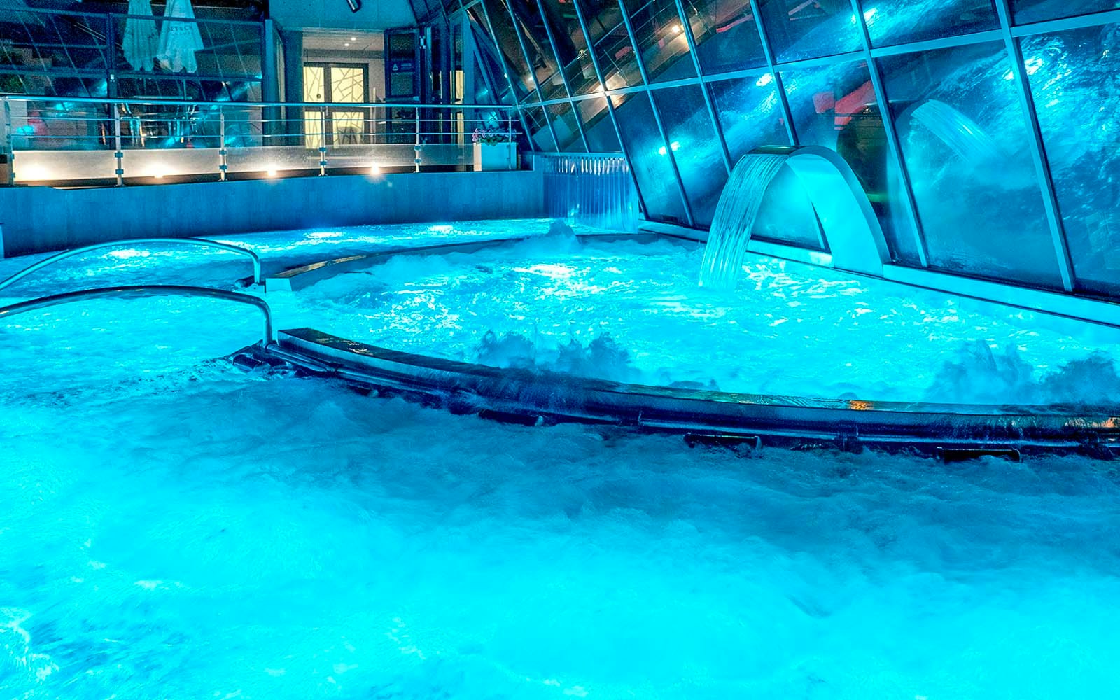 Caldea spa thermal pools with cascading water and mountain views in Andorra.
