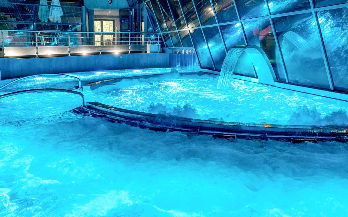 Caldea spa thermal pools with cascading water and mountain views in Andorra.