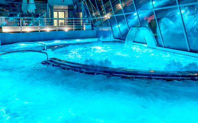 Caldea spa thermal pools with cascading water and mountain views in Andorra.
