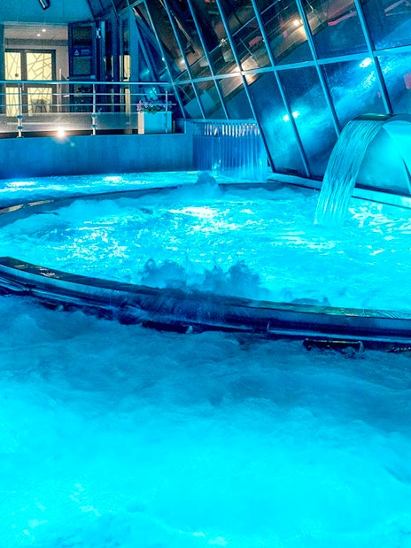 Caldea spa thermal pools with cascading water and mountain views in Andorra.