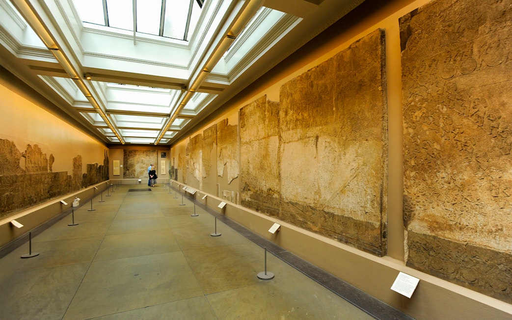 British Museum exhibition room with ancient wall carvings displayed.