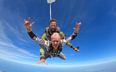 Skydiver tandem jumping at 13000 ft over Pattaya, Thailand.