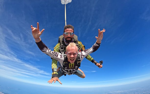 Skydiver tandem jumping at 13000 ft over Pattaya, Thailand.