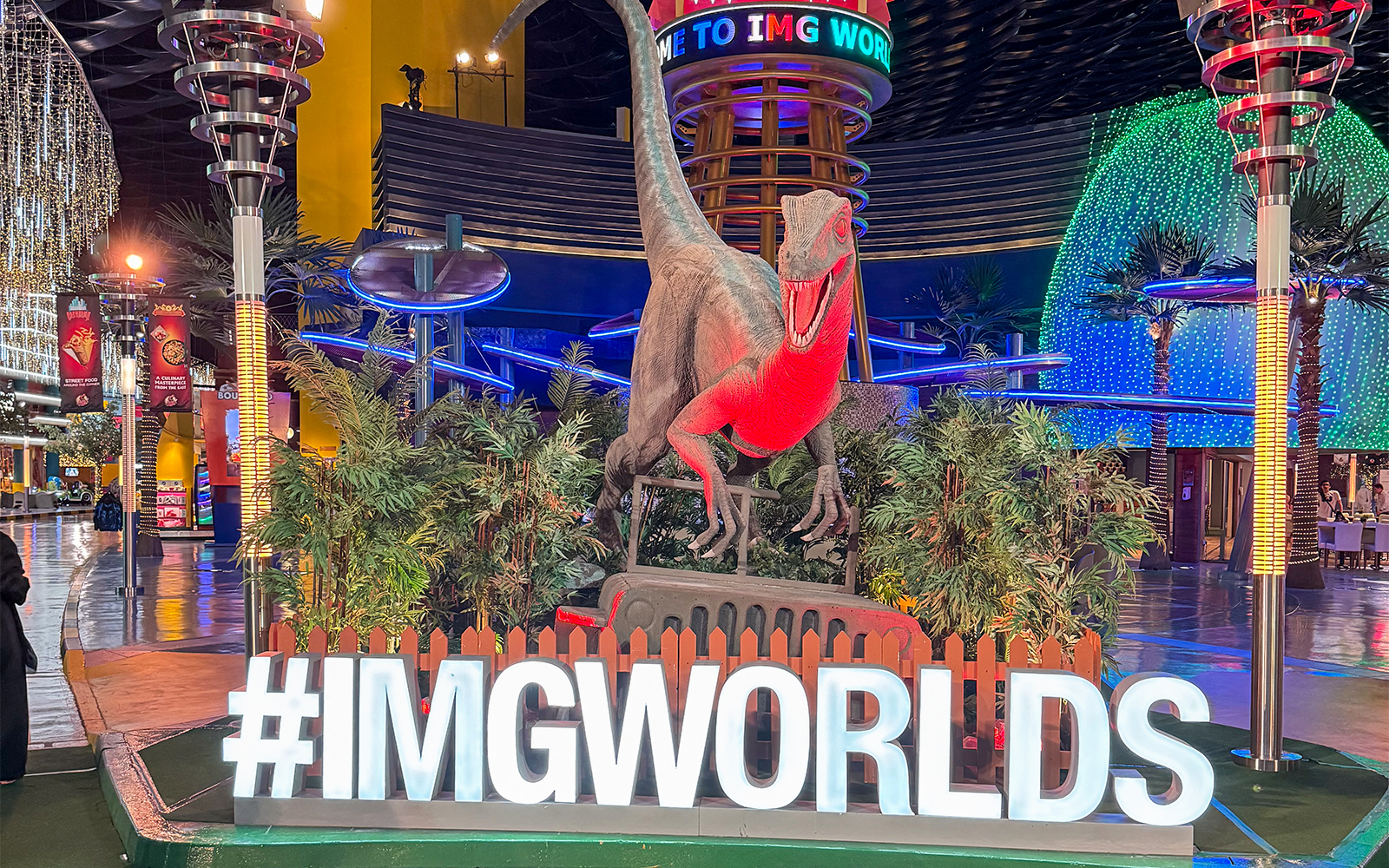 IMG Worlds of Adventure theme park entrance in Dubai with iconic dinosaur statue.