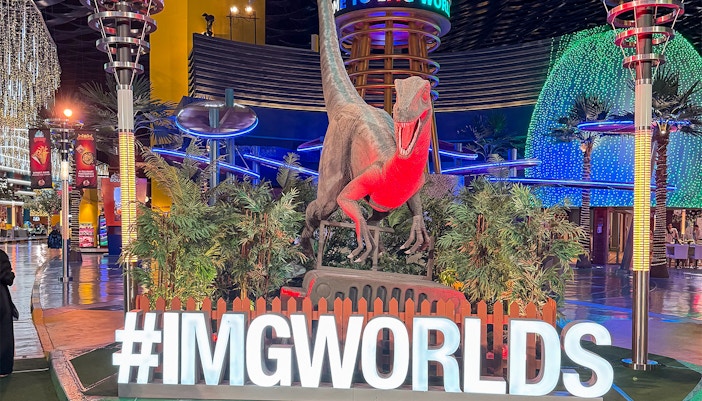 IMG Worlds of Adventure theme park entrance in Dubai with iconic dinosaur statue.