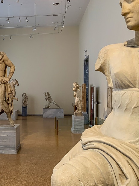 Exhibits of ancient sculptures inside National Archaeological Museum.