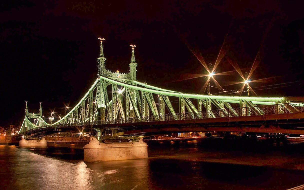 Liberty Bridge illuminated at night during New Year’s Eve Gala Dinner Cruise.