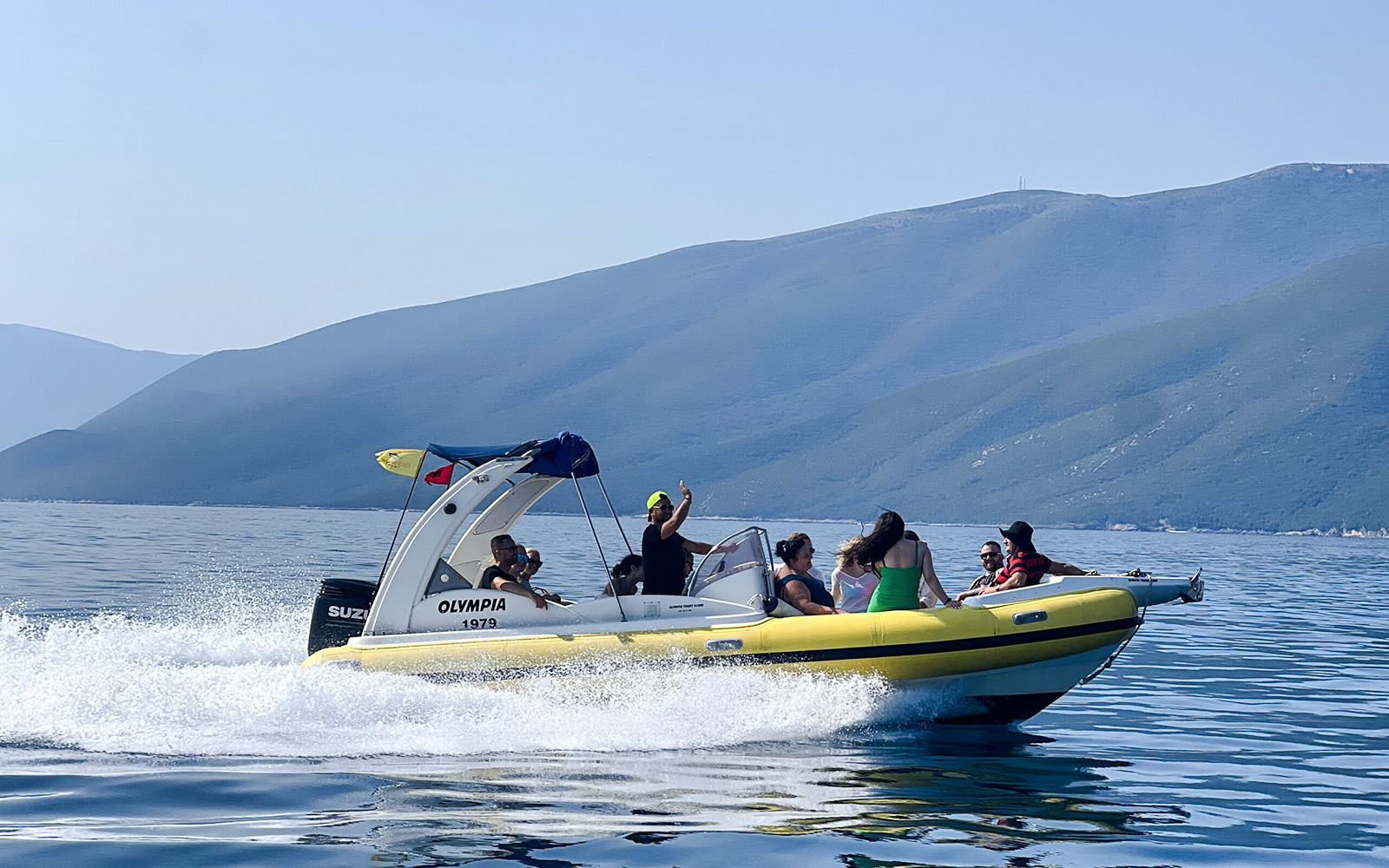 Speedboat with tourists on Sazan Island and Haxhi Ali Cave tour, Albania.