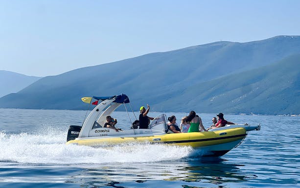 Speedboat with tourists on Sazan Island and Haxhi Ali Cave tour, Albania.