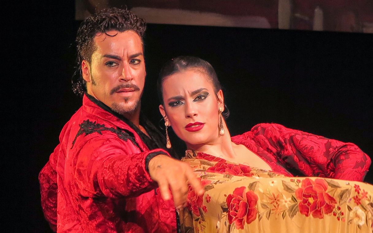 Flamenco dancers performing at Teatro Flamenco Triana in Seville.
