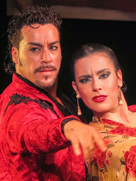 Flamenco dancers performing at Teatro Flamenco Triana in Seville.