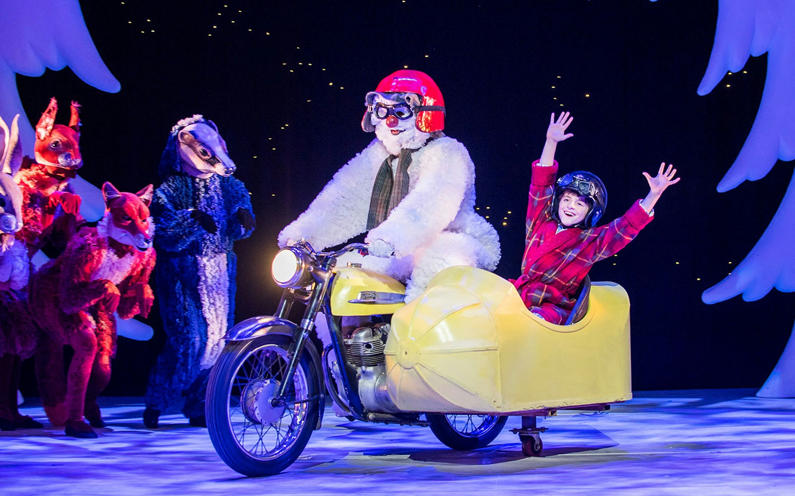 Snowman character and child in sidecar on stage during "The Snowman" performance.