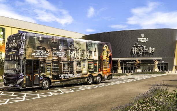 Warner Bros. Studio Tour London entrance with Harry Potter-themed bus.