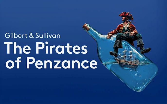 Pirate sitting on a bottle with a ship inside, promoting "The Pirates of Penzance.