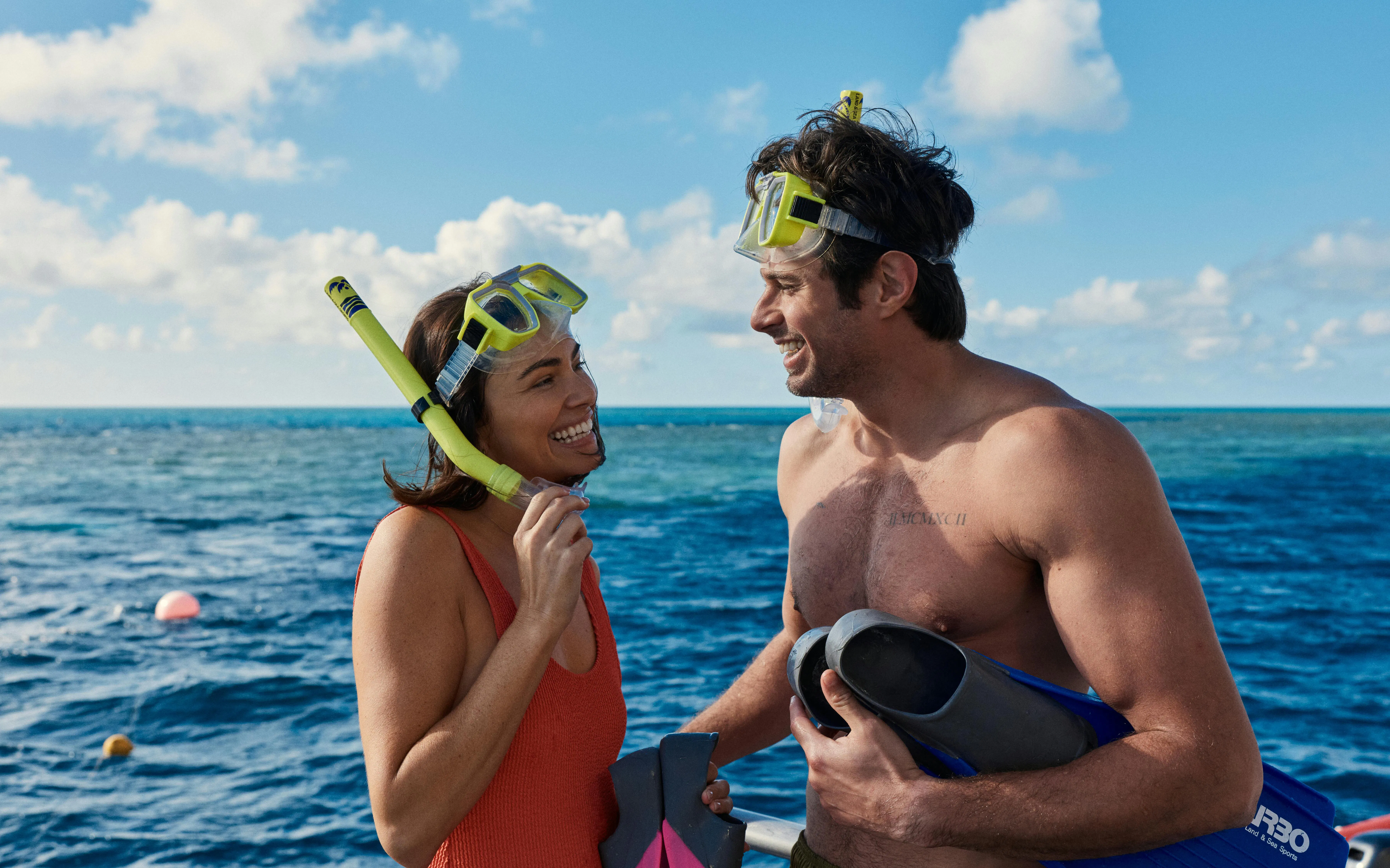 Snorkelers smiling on a boat during Whitehaven Beach tour, Whitsundays Island.