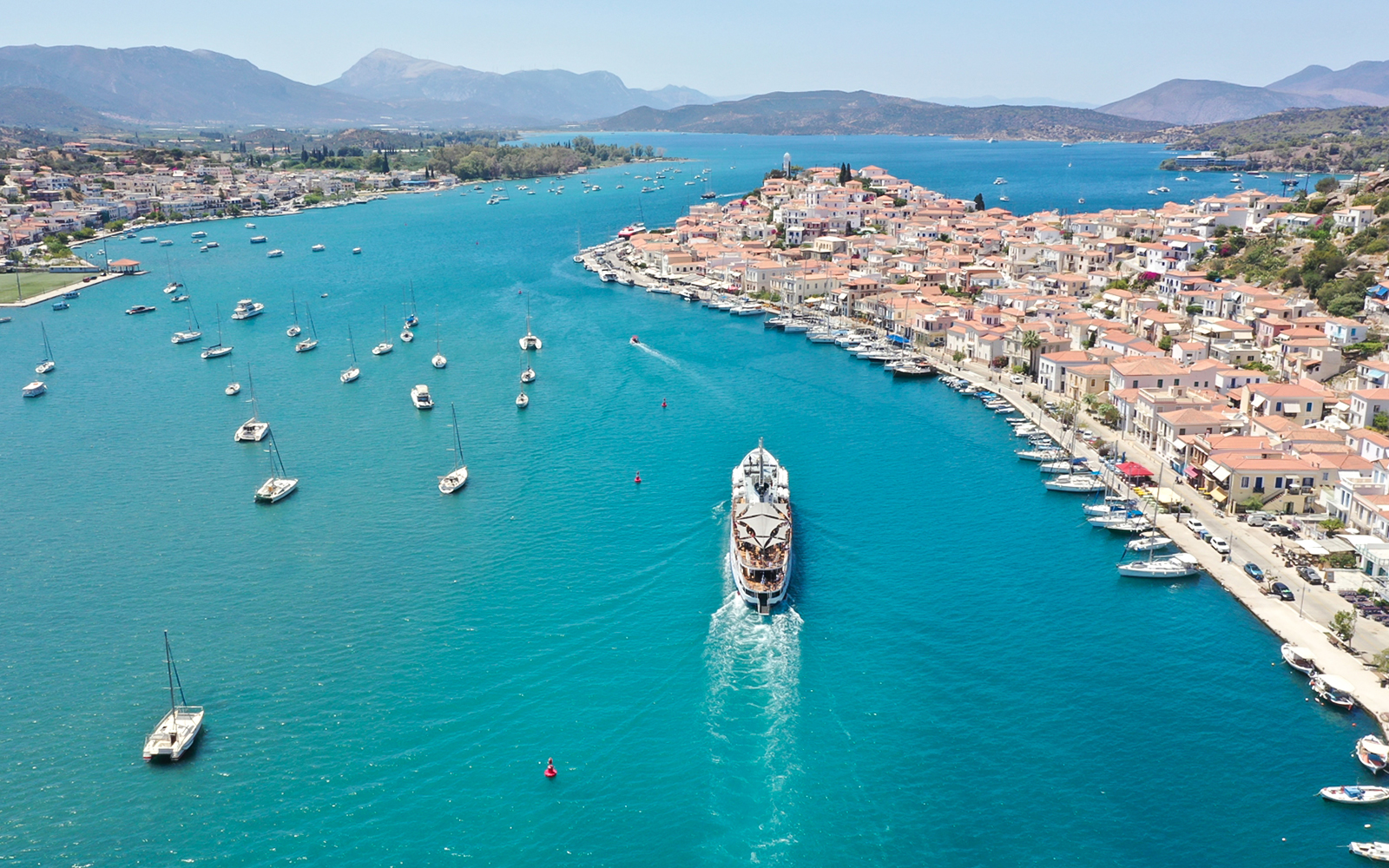 Aerial view of a cruise ship approaching Poros Island during the Athens Day Cruise.