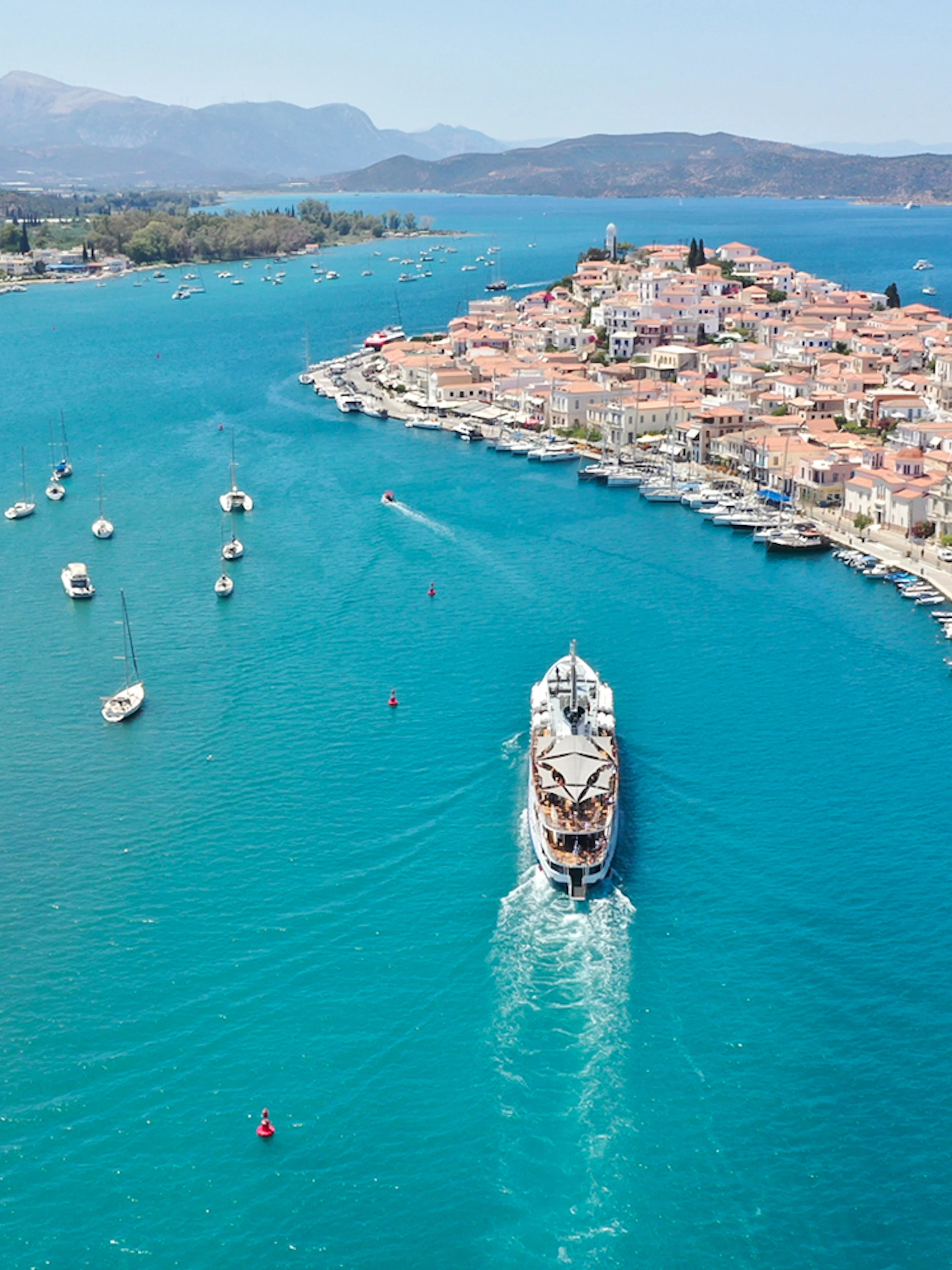 Aerial view of a cruise ship approaching Poros Island during the Athens Day Cruise.