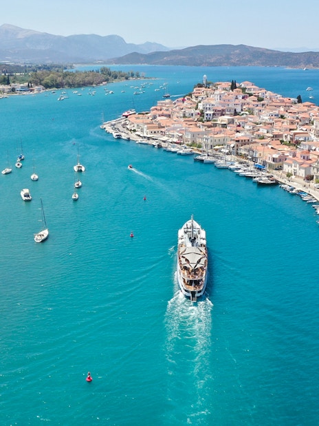 Aerial view of a cruise ship approaching Poros Island during the Athens Day Cruise.