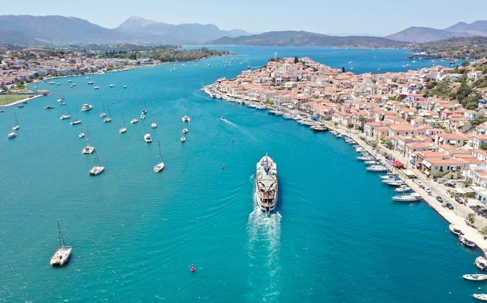 Aerial view of a cruise ship approaching Poros Island during the Athens Day Cruise.