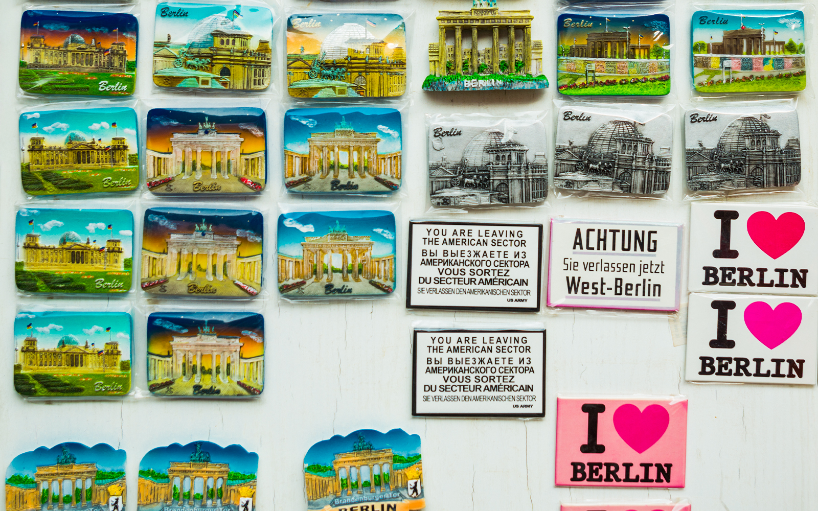 Colorful magnets featuring traditional German designs displayed in a Berlin gift shop.