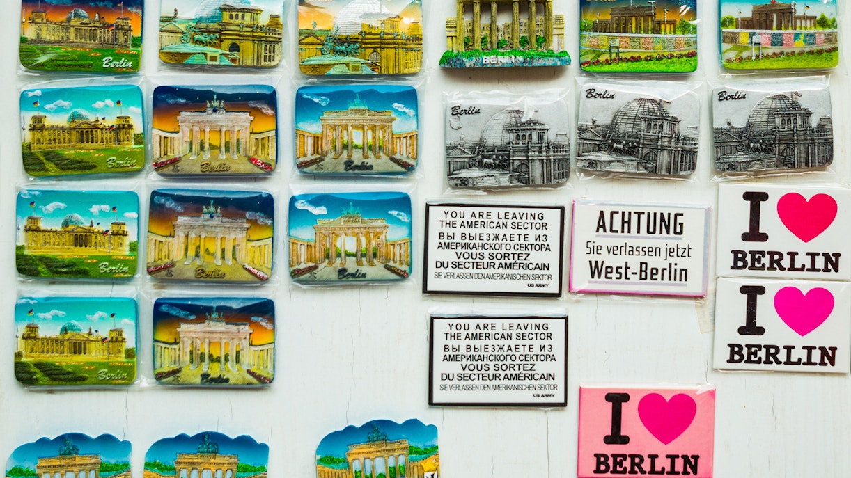 Colorful magnets featuring traditional German designs displayed in a Berlin gift shop.