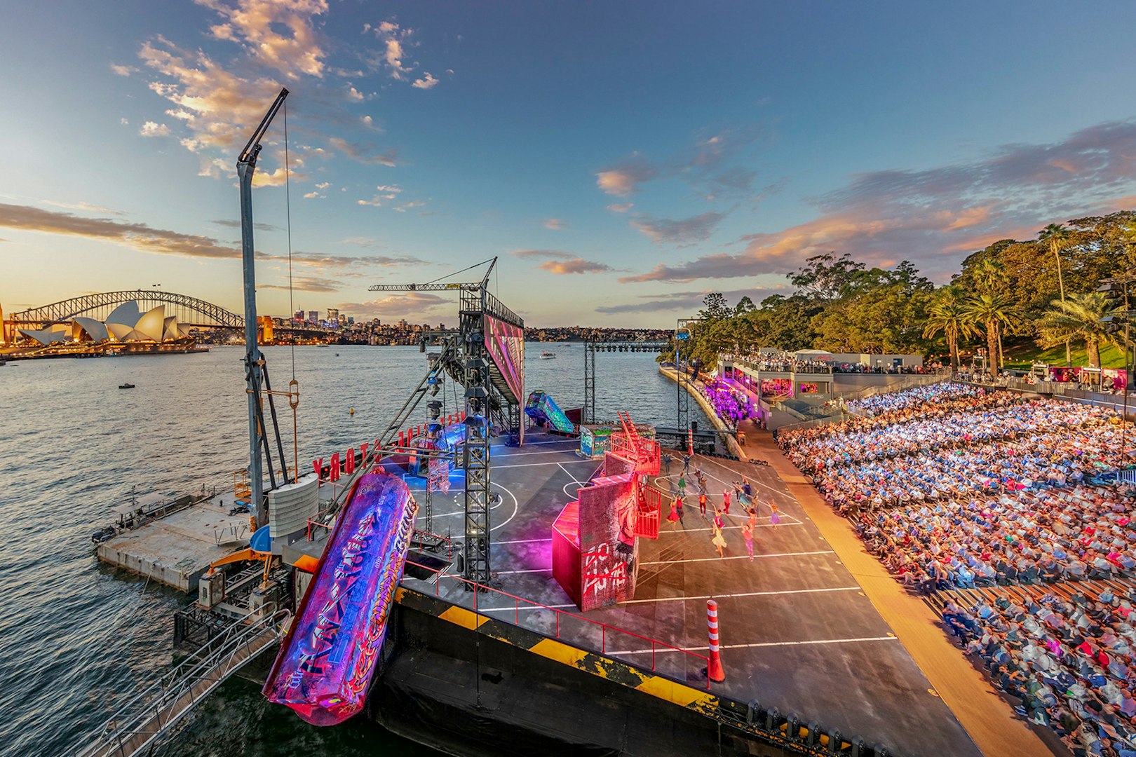 Open-air performance of West Side Story on Sydney Harbour with Opera House and Harbour Bridge in view.