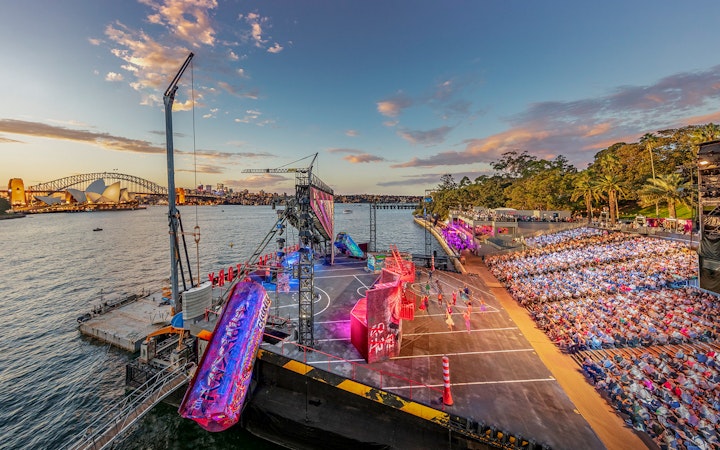 Open-air performance of West Side Story on Sydney Harbour with Opera House and Harbour Bridge in view.