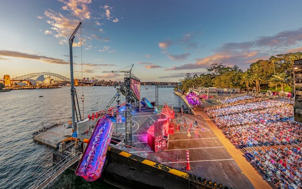 Open-air performance of West Side Story on Sydney Harbour with Opera House and Harbour Bridge in view.