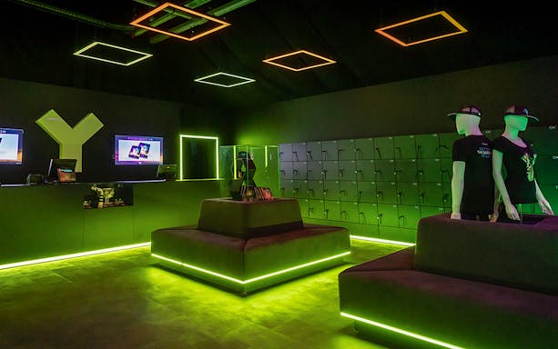YULLBE GO VR Experience lobby with neon lighting and VR equipment lockers.